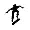 Black skateboarder man doing extreme jump while flipping a skateboard