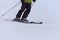 Black skier skiing down snowy hill