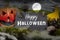 Black slate chalkboard with happy halloween pumpkin decoration with fog and cemetery