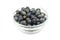 Black sloe berries in a glass bowl