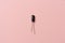 A black small capacitor on pink background