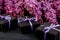 Black small gift boxes wrapped purple ribbon with natural lilac