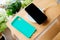 Black smartphone and mint silicone case is charged from a wireless charger.