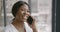 Black smiling woman nutritionist talking by phone