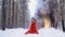 Black smoke rises slowly due to snowdrift behind a girl in a red dress