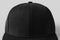 Black snapback cap mockup on a grey background, closeup