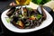 Black spaghetti. Black seafood pasta with mussels over black background.