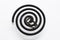 Black spiral mosquito repellent coil on white background