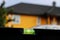 Black spirit level on a background of a yellow house with a black roof