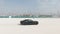 Black sport car test drive on Dubai beach