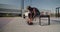 Black sportsman tying shoelaces on bench