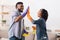 Black Spouses Giving High Five To Each Other After Spring-Cleaning Home