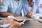 Black spouses holding hands sitting in investment advisor`s office, cropped