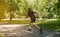 Black sprinter running at park on sunny morning, free space