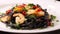 Black squid ink Fettuccine pasta with prawns or shrimps cherry tomatoes, parsley, chili in wine and butter sauce. Zoom in shot