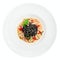 Black squid ink pasta with seafood in plate, isolated