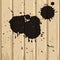 Black stains on beige wood background