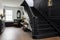 black staircase in a white tudor style interior