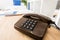 black stationary telephone on wooden table