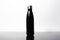 Black steel thermos, eco bottle for water, on black glass, background of white.