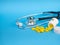 Black stethoscope for doctor and yellow pills and plastic white bottle. Healthcare concept. Blue background with copy space for