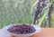 Black sticky rice berry on the plate with blurred ripe of black sticky paddy rice seed, rice berry paddy seed