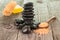 Black stones, bath salt and loofa on weathered deck