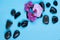 Black stones and flowers for massage and procedures in a spa salon on a blue background