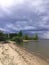 black storm clouds over the lake shore. an impending thunderstorm