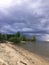 black storm clouds over the lake shore. an impending thunderstorm