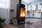 Black stove, fireplace in interior of house in loft style. Alternative eco-friendly heating, warm cozy room at home, burning wood