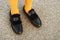 Black strap leather shoes with faux fur and yellow tights