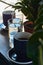 Black and strong morning coffee in blue mugs and green plants in pots.