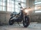 Black stylish motorcycle standing in a destroyed old building