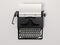 Black stylish typewriter with blank paper sheet. 3d rendering