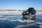 Black Subaru Forester with rooftop box at frozen lake ice