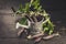 Black sugar peas in a decorative watering can on a dark rustic background. Vintage composition. Farm Organic Products Concept