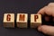 On a black surface, a man puts cubes with the inscription - GMP