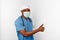 Black surgeon doctor man in blue coat white cap and surgeon mask with thumbs up gesture