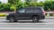 Black SUV car Toyota Land Cruiser 200 at the city highway. Auto moving at high speed on the street