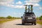 Black SUV with three bicycles on roof rack