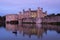 Black swans in the lake at Leeds Castle near Maidstone in Kent UK. Castle is reflected in the surrounding lake.