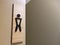 Black Symbol of Men`s Toilet on Wooden Board
