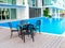 Black table and chairs near a cool pool