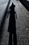 Black tall silhouette on a dark urban floor