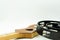 Black tambourine on a four-stringed wooden guitar on white background. Acoustic instrument concept