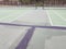 Black tar to repair cracks on green tennis court