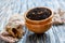 Black tea with bergamot and flower petals in wooden bowls.