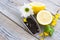 Black tea ceremony - glass full of tea, sugar, yellow lemon, tea leaves, spices on a wooden boards background