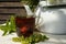 black tea glass cup white kettle table sunlight close-up